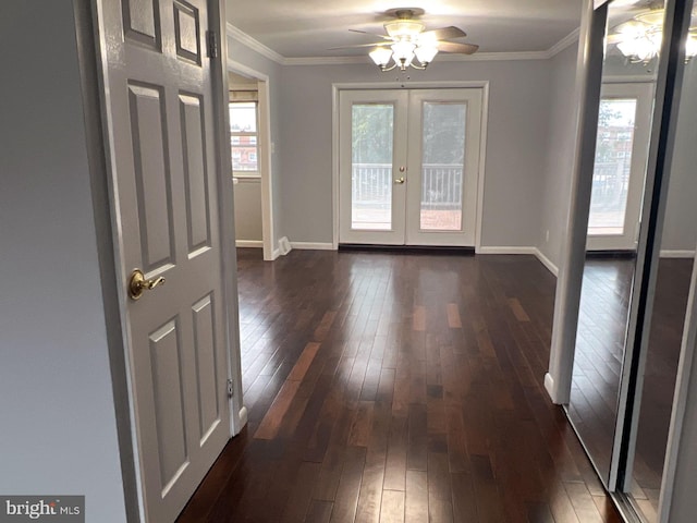 doorway featuring dark wood-type flooring, french doors, ceiling fan, and crown molding