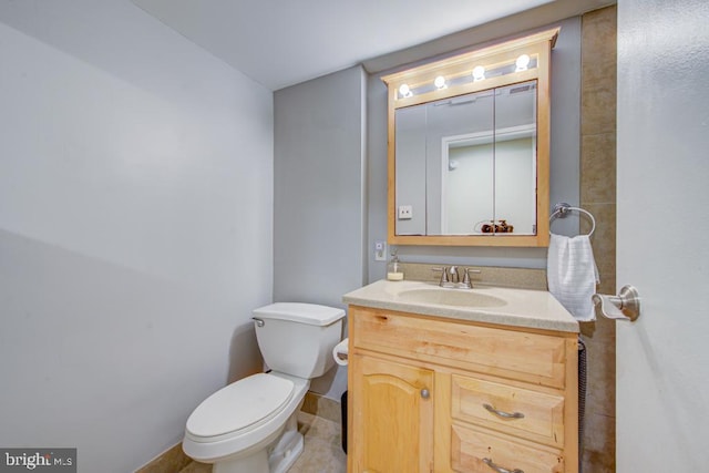 bathroom with vanity, toilet, and tile patterned floors