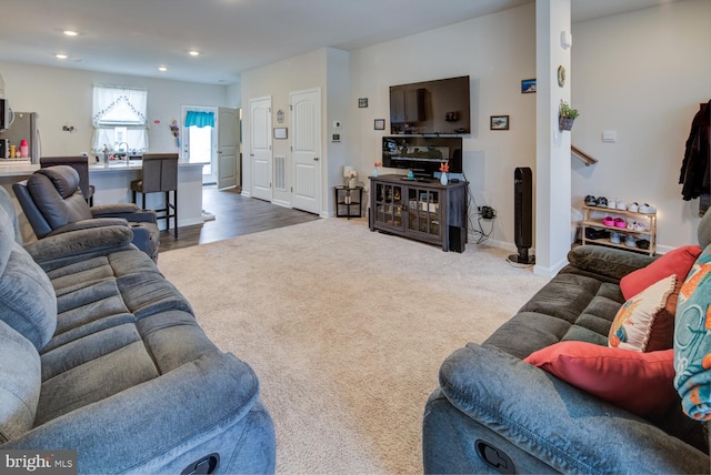 living room featuring dark colored carpet and sink