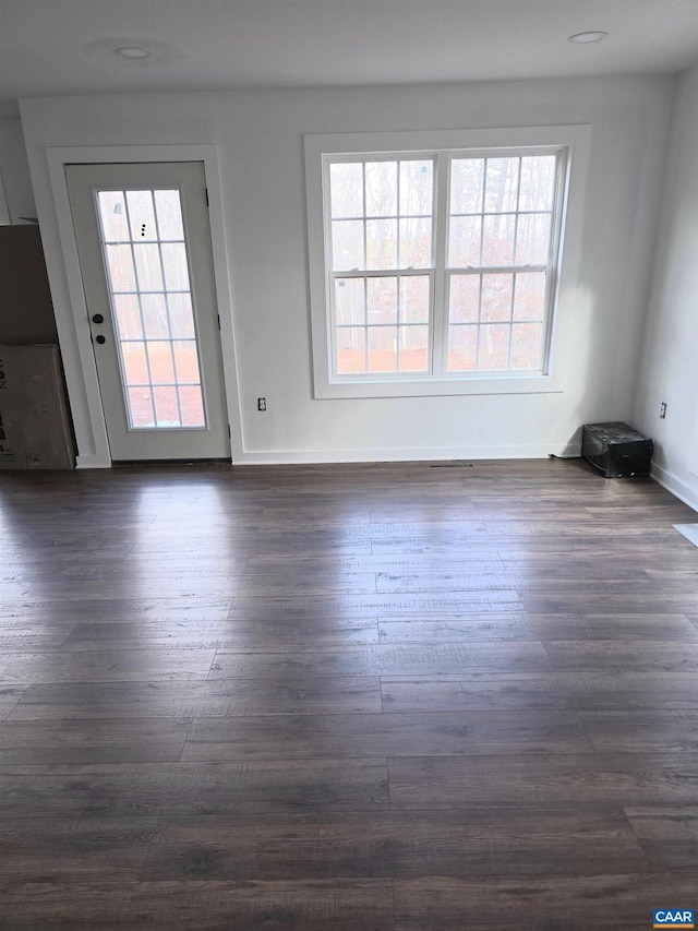 spare room with dark wood-style floors and baseboards