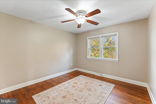 empty room featuring ceiling fan and dark hardwood / wood-style flooring