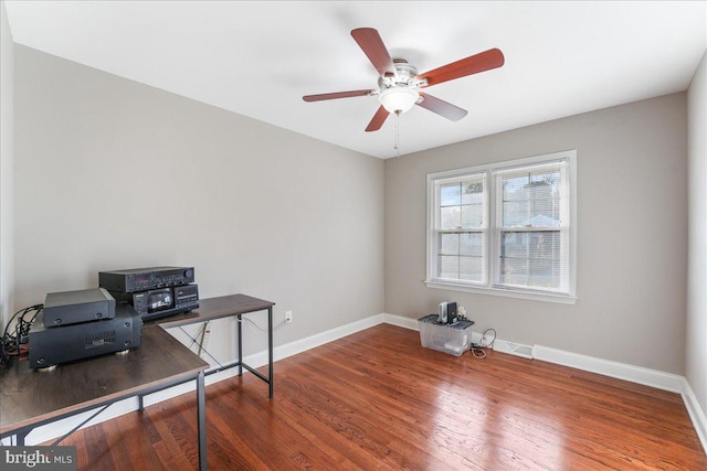 home office with hardwood / wood-style floors and ceiling fan