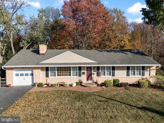 single story home with a garage and a front yard