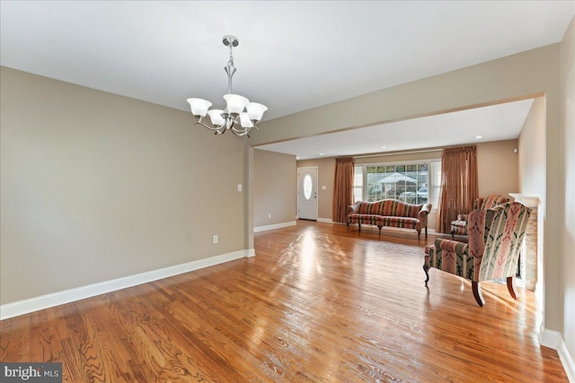 interior space with hardwood / wood-style floors and a notable chandelier