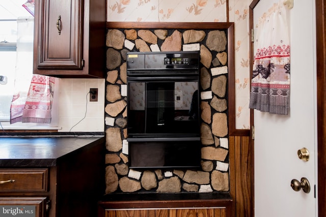 2217 N 59th St, Philadelphia, PA 19131 - kitchen view of dark countertops, decorative backsplash, and dark brown cabinetry