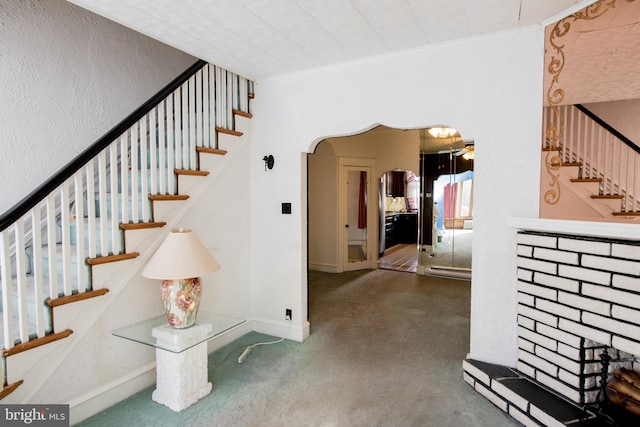 stairs with concrete flooring and crown molding