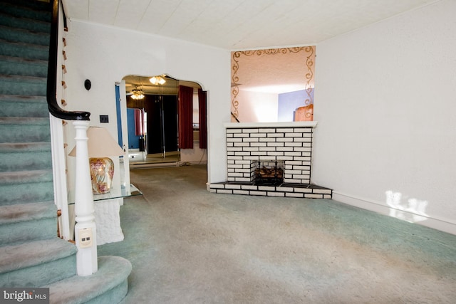 carpeted living room with a brick fireplace