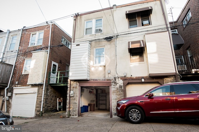 2217 N 59th St, Philadelphia, PA 19131 - view of front of property featuring stone siding, stucco siding, a garage, and driveway