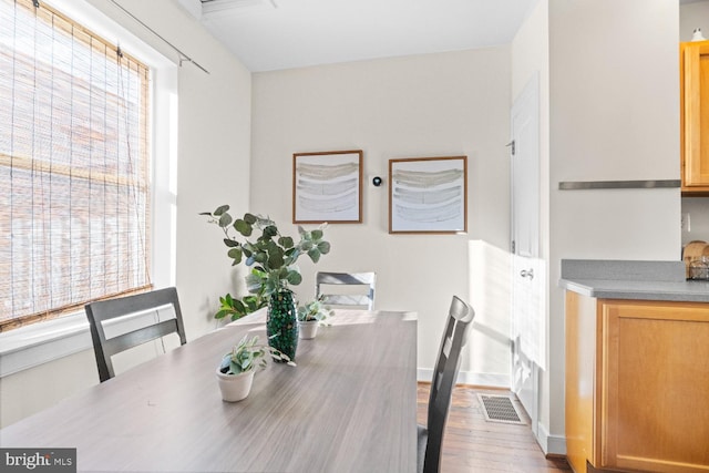 dining area featuring plenty of natural light and light hardwood / wood-style floors