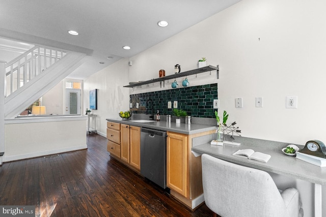 kitchen featuring dark hardwood / wood-style flooring, sink, stainless steel dishwasher, backsplash, and light brown cabinetry