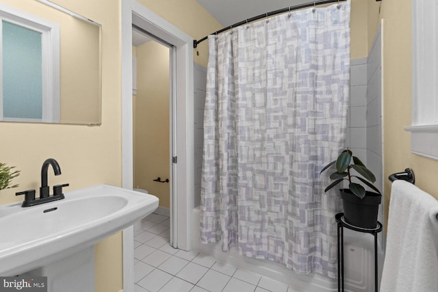 bathroom with shower / bath combo, sink, and tile patterned flooring