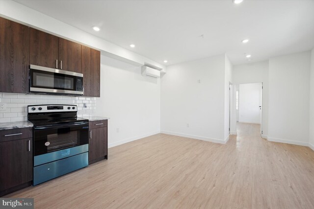 kitchen featuring light hardwood / wood-style floors, dark brown cabinetry, tasteful backsplash, light stone countertops, and appliances with stainless steel finishes
