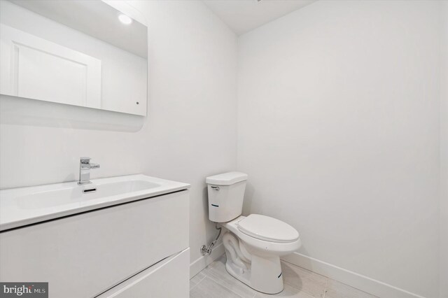bathroom with tile patterned floors, vanity, and toilet