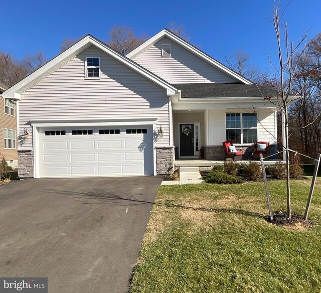 view of front of property with a garage and a front lawn