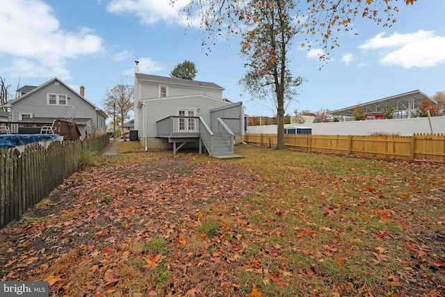 back of property featuring a wooden deck