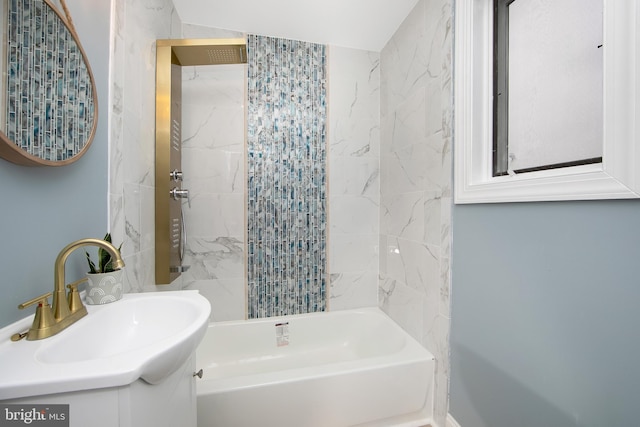 bathroom featuring vanity and tiled shower / bath