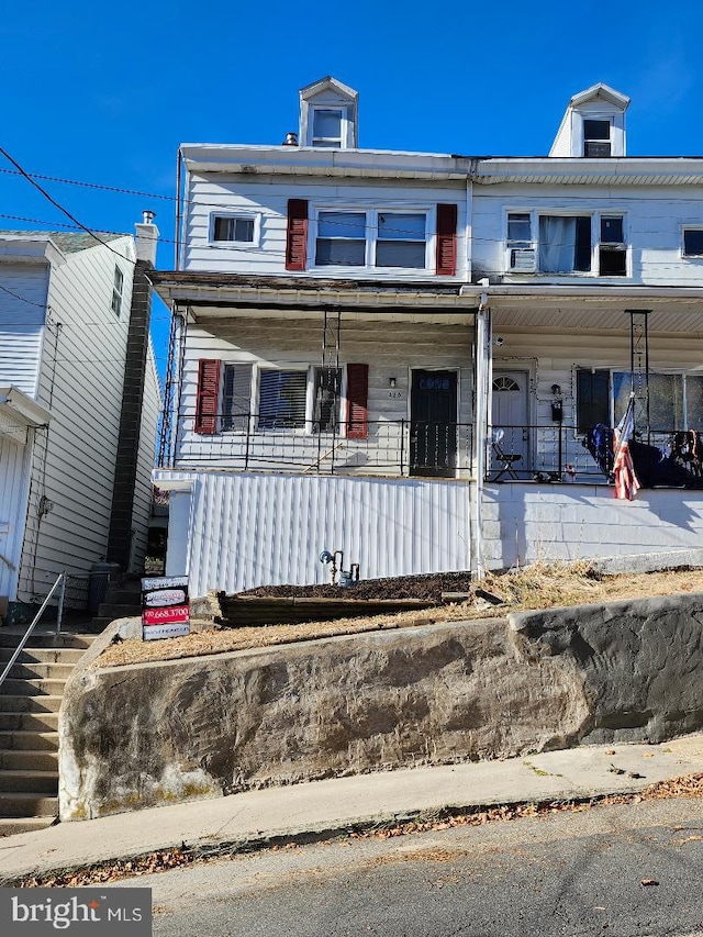 townhome / multi-family property featuring a porch