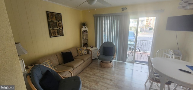 living room featuring ceiling fan, light hardwood / wood-style flooring, and ornamental molding