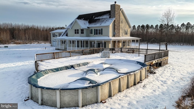 snow covered house with a porch