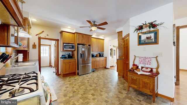 kitchen with ceiling fan, appliances with stainless steel finishes, and sink