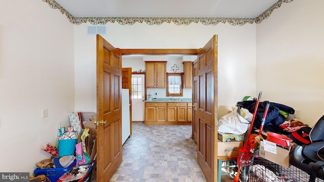 kitchen featuring sink and white fridge