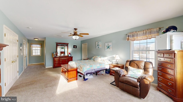 bedroom with light carpet and ceiling fan