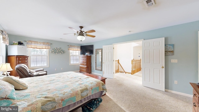 bedroom with light carpet and ceiling fan