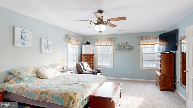 bedroom with ceiling fan and light carpet