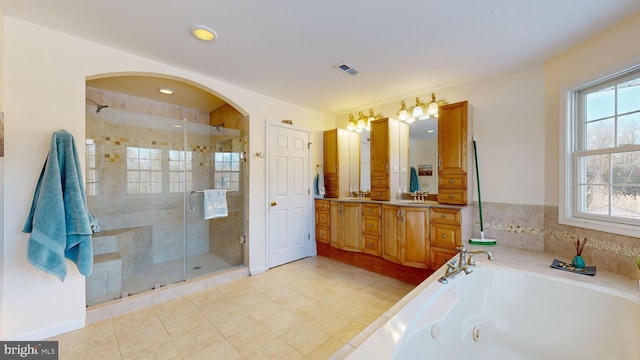 bathroom with vanity and independent shower and bath