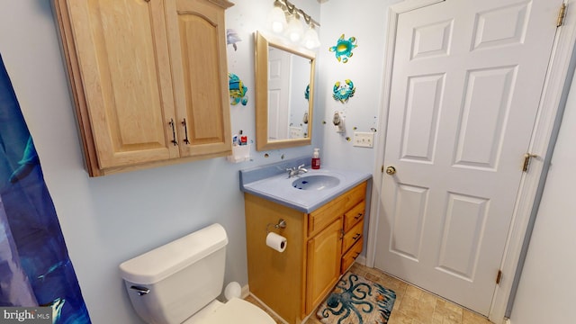 bathroom featuring vanity and toilet