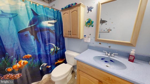 bathroom featuring vanity, tile patterned flooring, a shower with curtain, and toilet