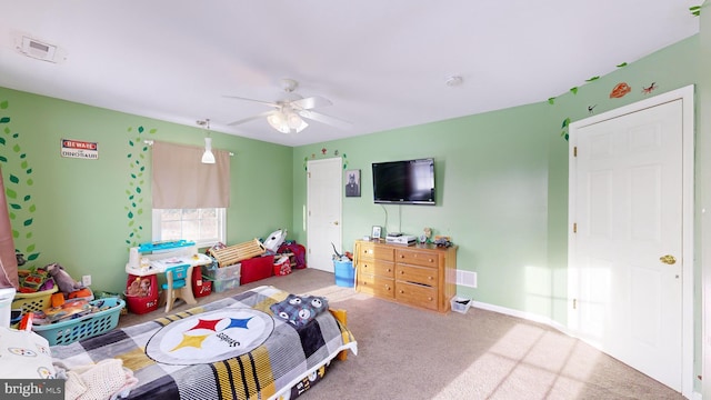 bedroom with ceiling fan and light carpet