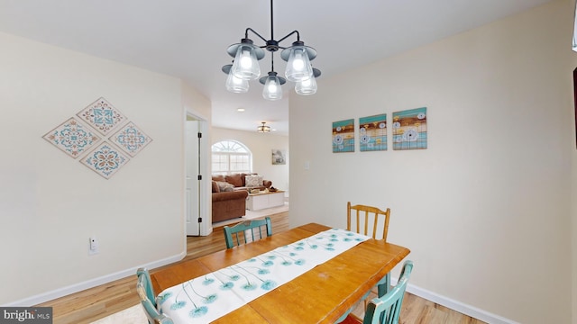 dining area featuring a chandelier and light hardwood / wood-style floors