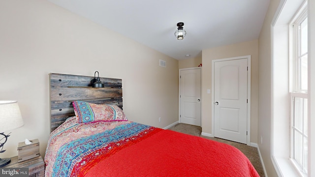 bedroom with light colored carpet