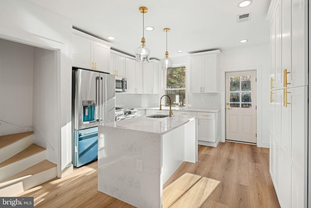 kitchen with sink, white cabinetry, and stainless steel appliances