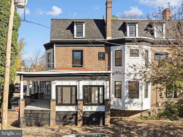 rear view of property featuring covered porch