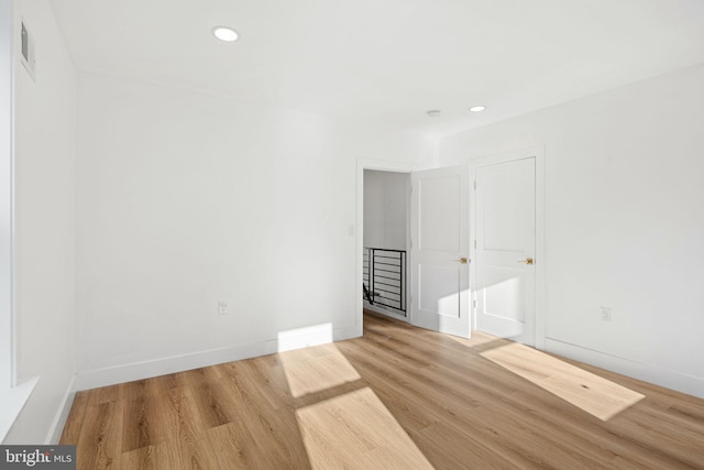 spare room with light hardwood / wood-style flooring