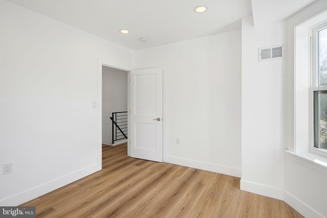 unfurnished room with light wood-type flooring