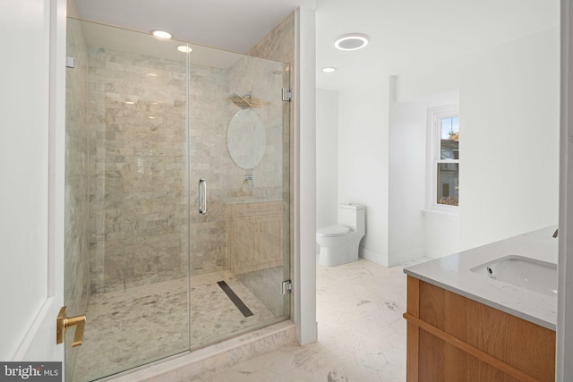 bathroom with an enclosed shower, vanity, and toilet