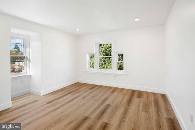 spare room featuring light hardwood / wood-style floors