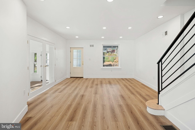 foyer featuring french doors and light hardwood / wood-style floors