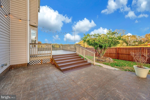 view of patio / terrace with a deck with water view