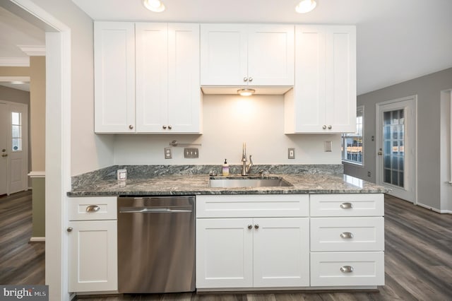 kitchen with dark hardwood / wood-style flooring, dark stone counters, dishwasher, white cabinets, and sink