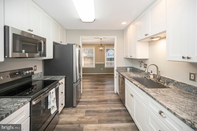 kitchen featuring white cabinets, stainless steel appliances, sink, and dark hardwood / wood-style flooring