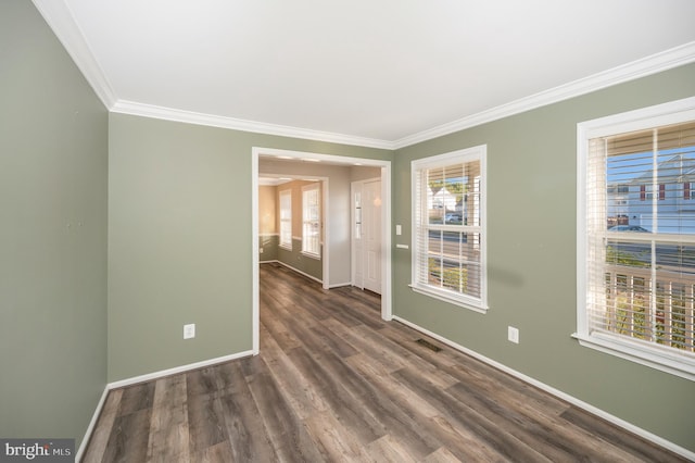 unfurnished room with ornamental molding and dark hardwood / wood-style floors