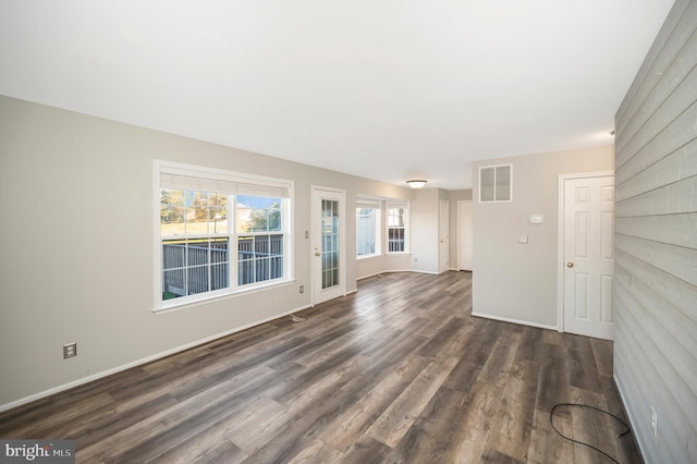 unfurnished living room featuring dark hardwood / wood-style floors