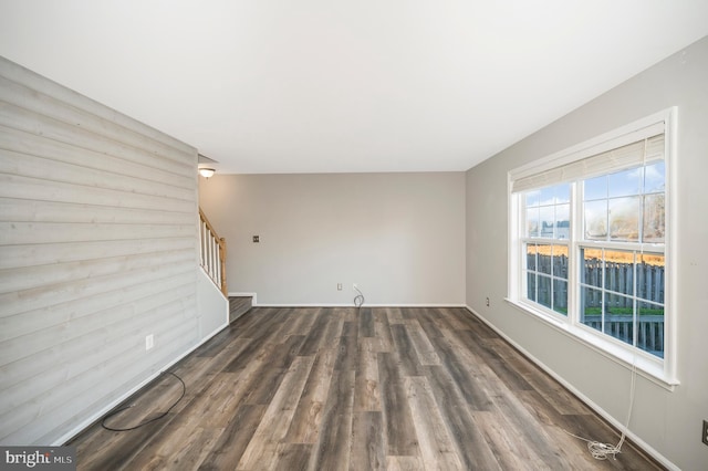 unfurnished living room featuring dark wood-type flooring