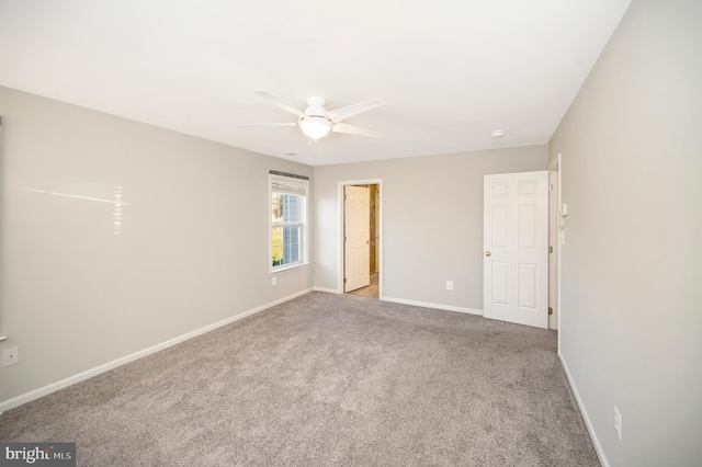 spare room with light carpet and ceiling fan