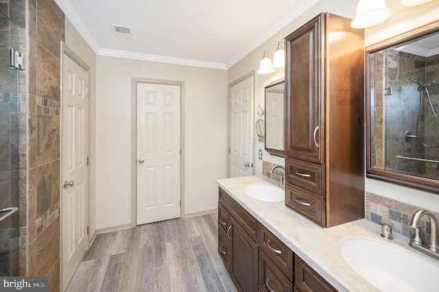 bathroom with vanity, hardwood / wood-style floors, and ornamental molding