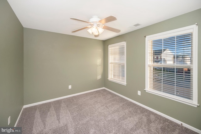 carpeted spare room with ceiling fan